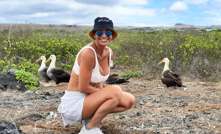 Girl in front of the waved albatrosses at Punta Cevallos en Española